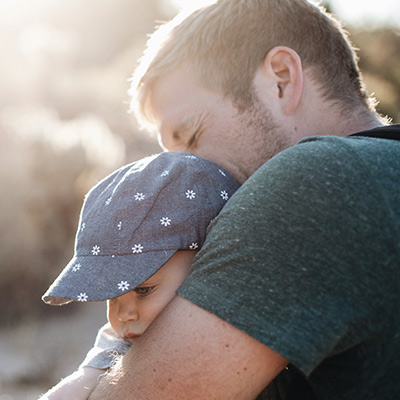 Parent hugging child outside