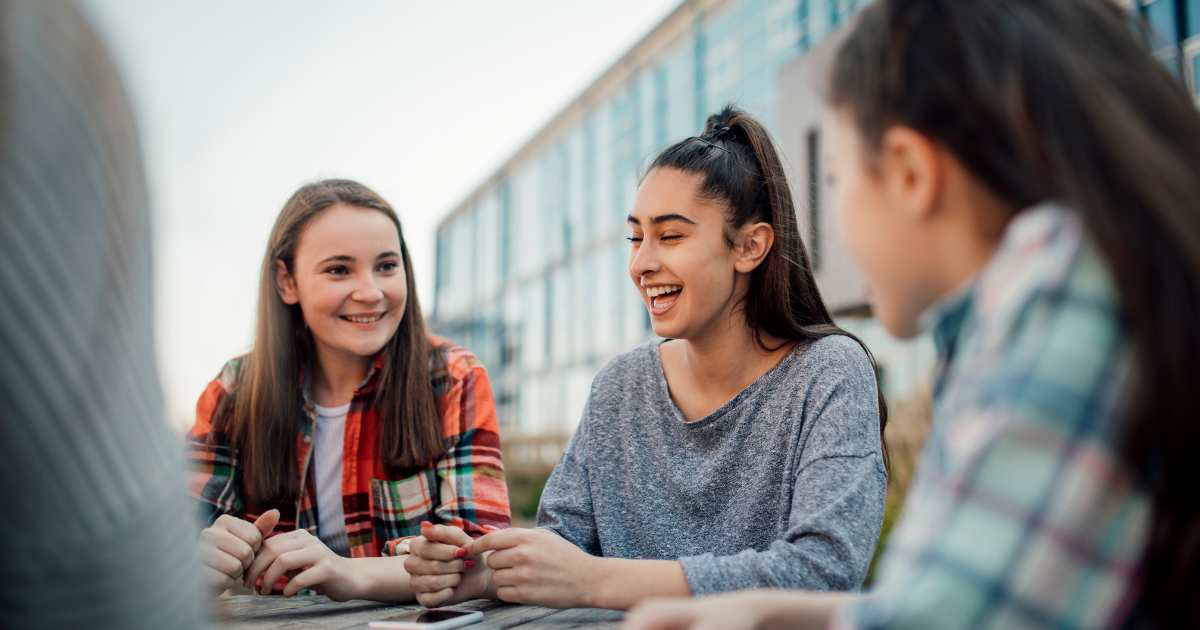 Four young people hanging out outdoors