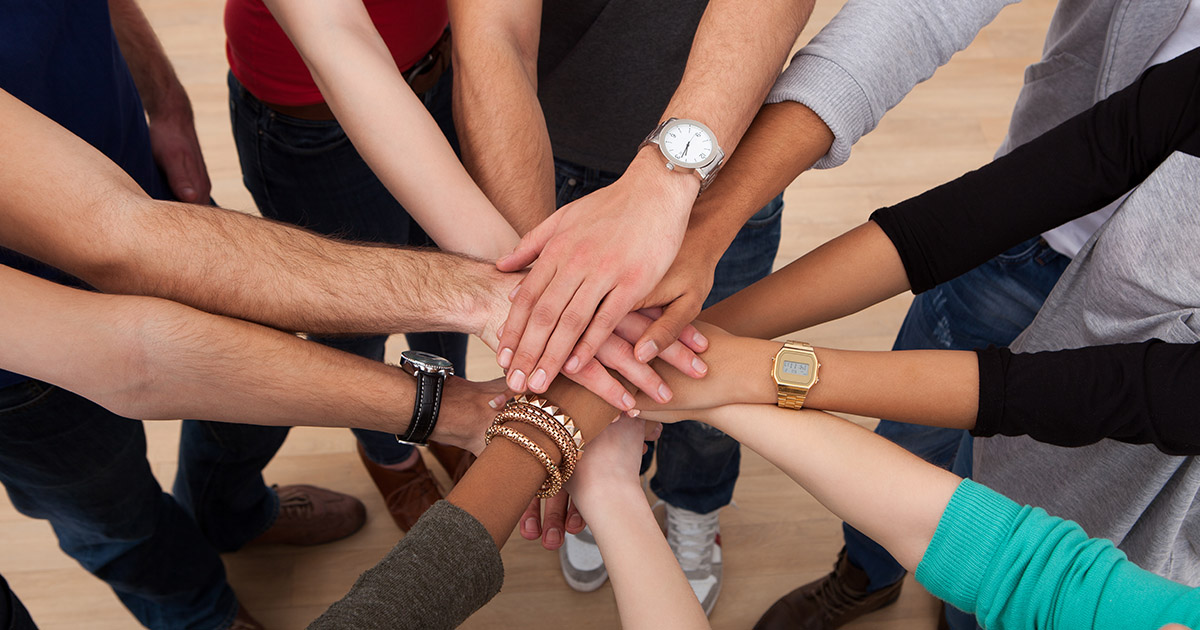 hands of people joining together for the future