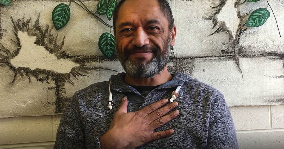 Smiling man with hand on chest