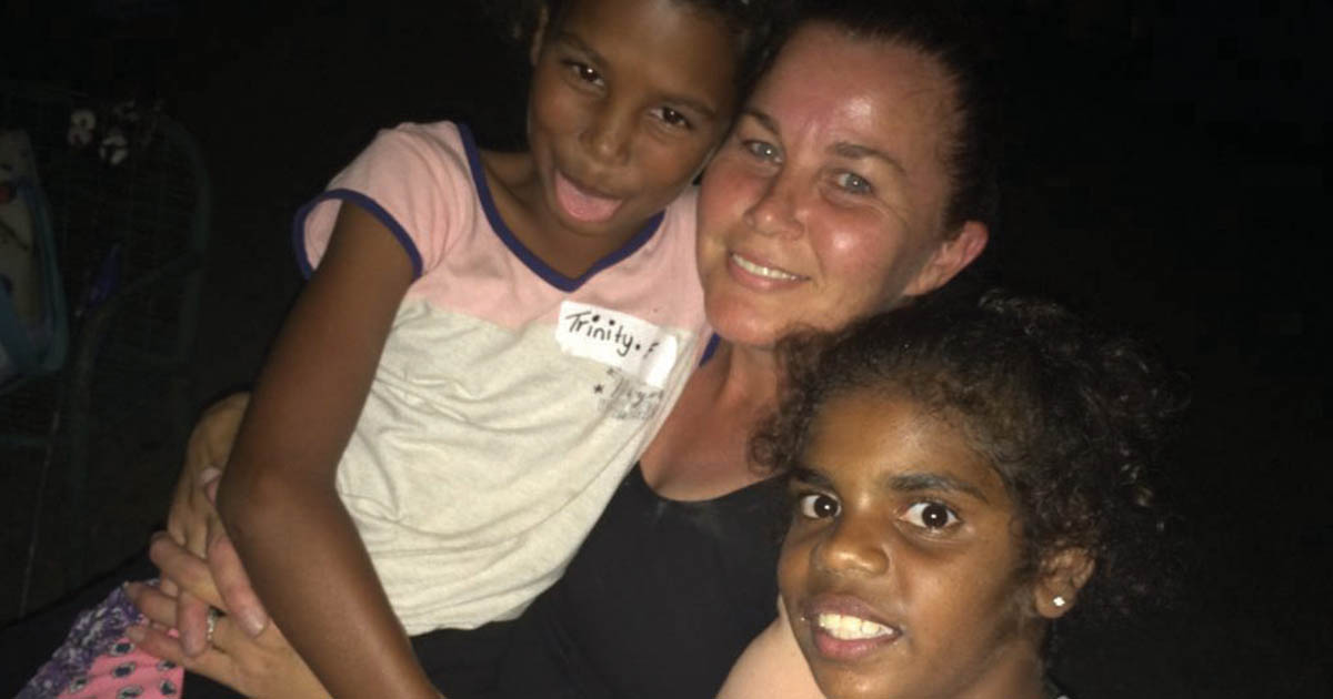 Caseworker smiling with kids