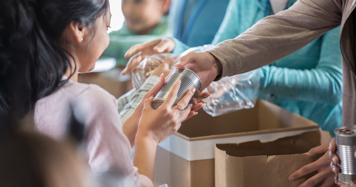 a kid receive a help donation from charity
