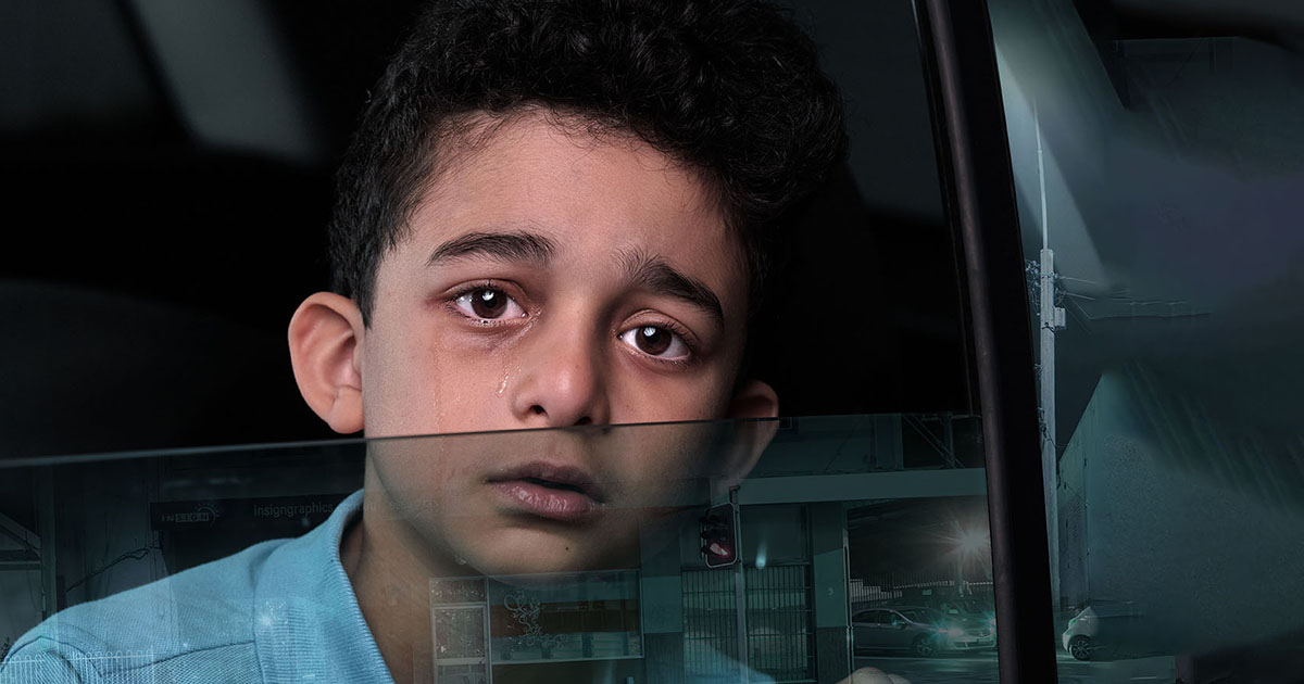A boy looking worried being homeless in the car