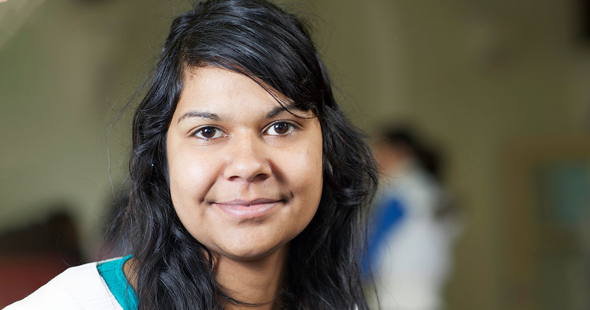 An indigenous woman looking happy