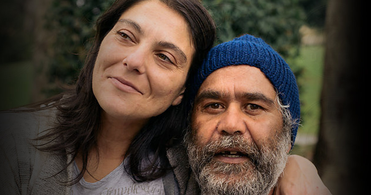 Two homeless people on a bench