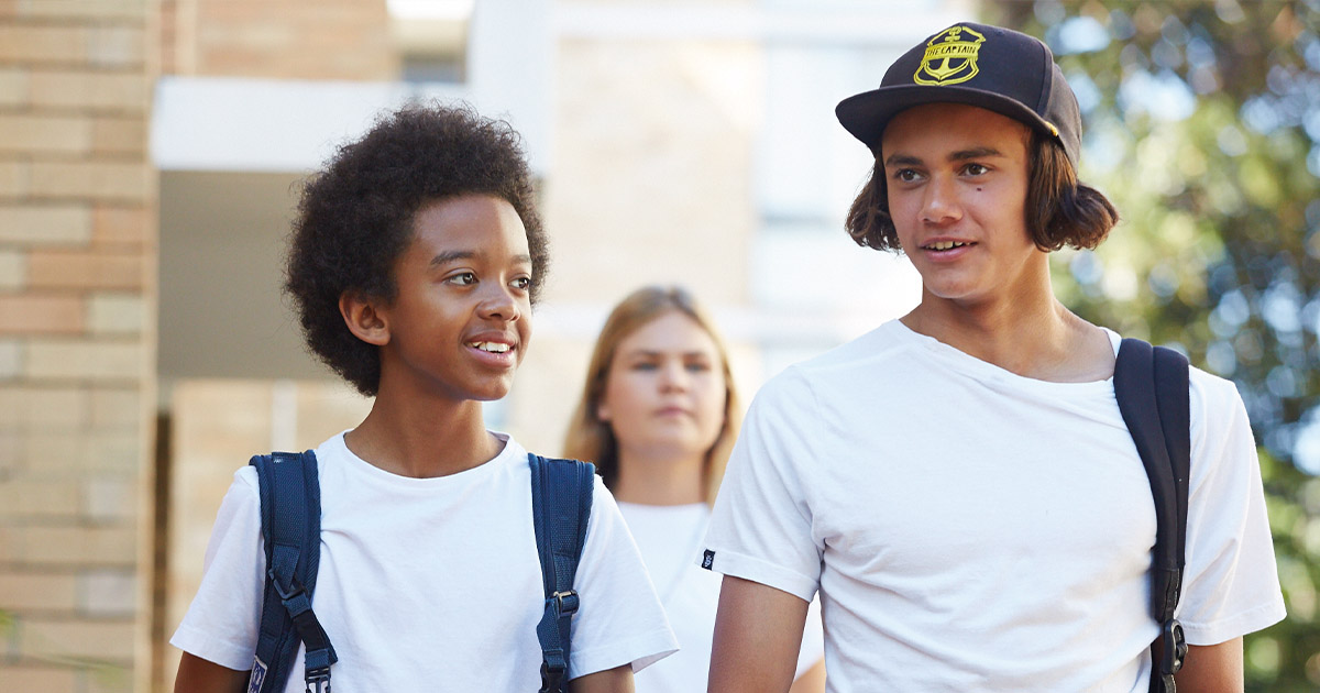 Three young people walking down the street