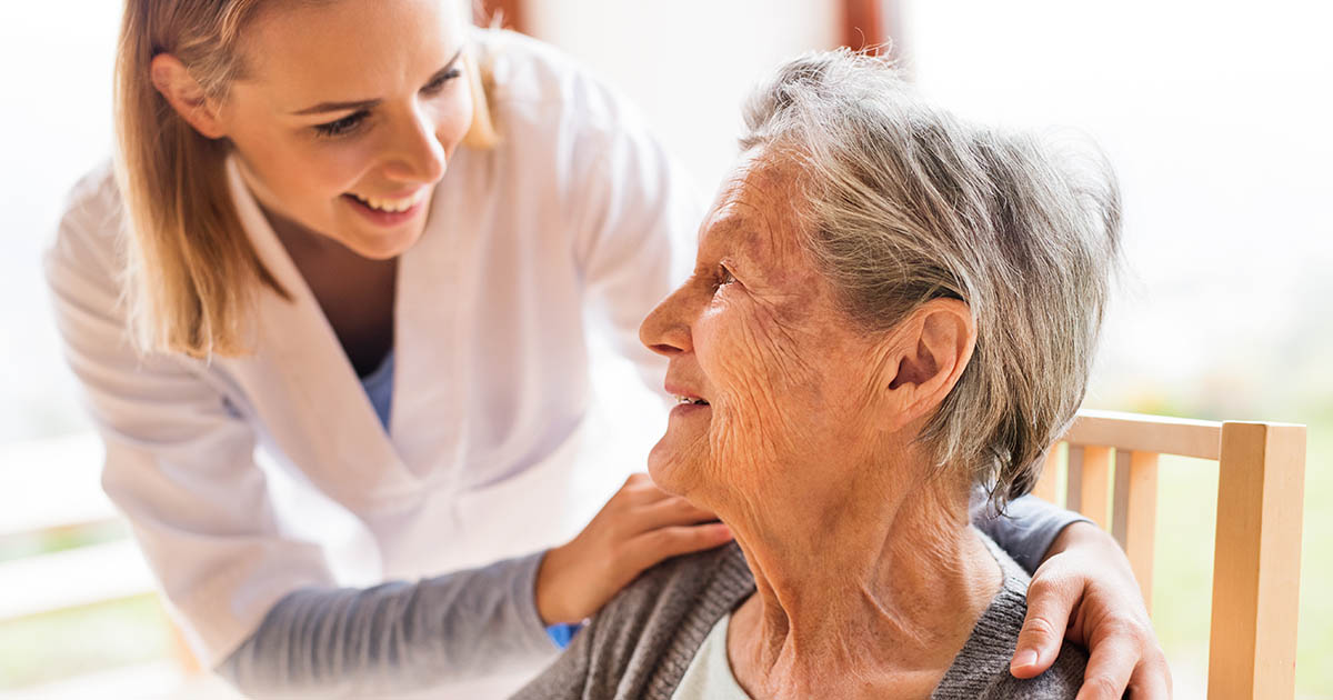 Young lady caring for elderly woman