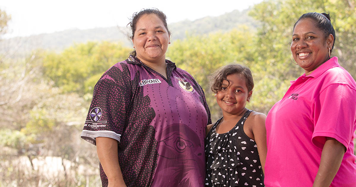 Woman looking happy together with Mission Australia staff