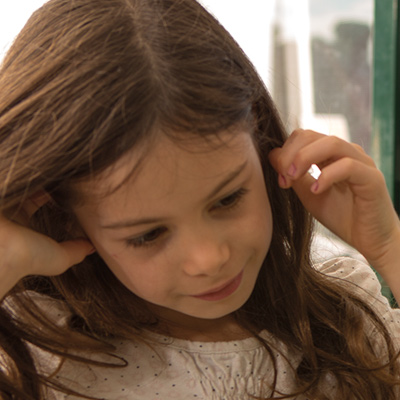 Little girl putting Christmas decorations up