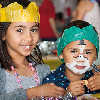Two kids with party hats on