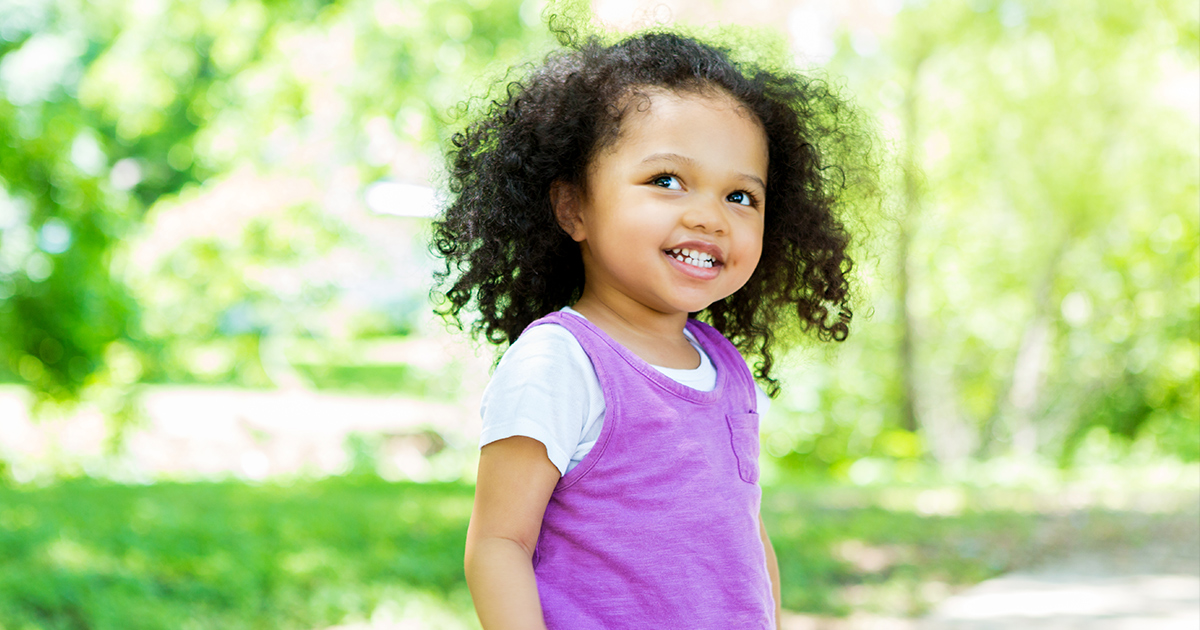Little girl smiling in a park