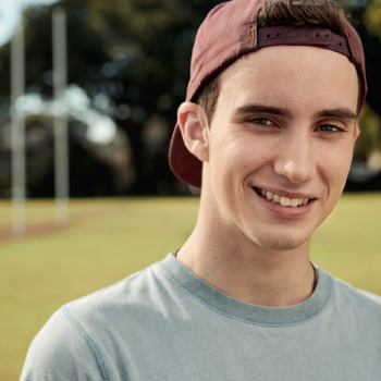 Young boy smiling in a park