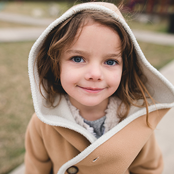 Little girl smiling in a hoodie