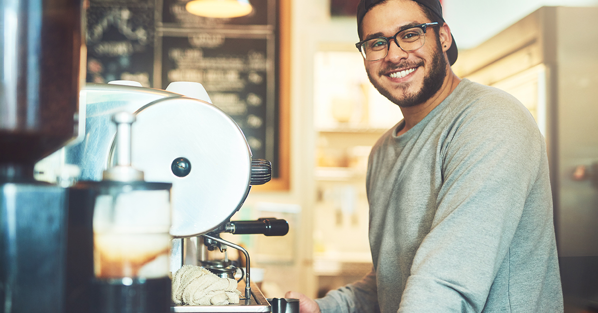 Young man brewing coffee