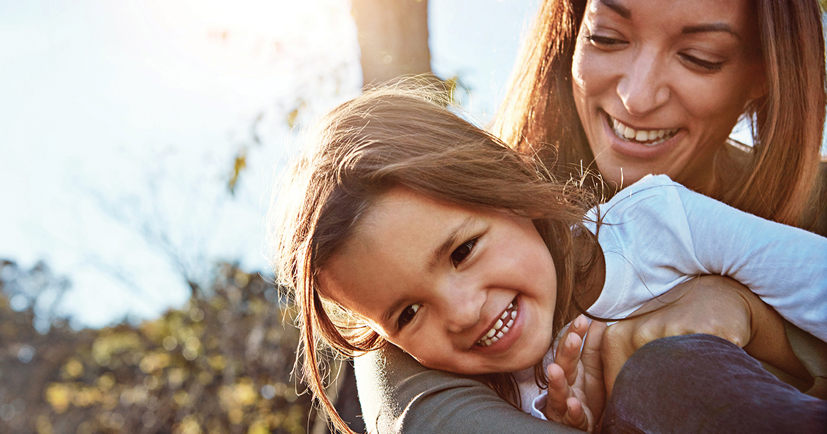 Little girl being hugged by mum